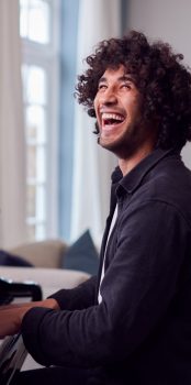 young-man-sitting-at-grand-piano-and-playing-at-ho-2021-08-30-06-14-52-utc.jpg